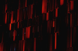 a dark room with a red light coming from the ceiling