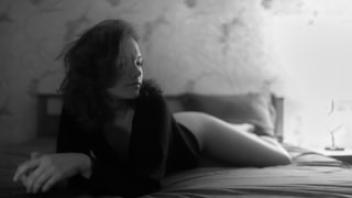 Woman lying on a bed in black and white